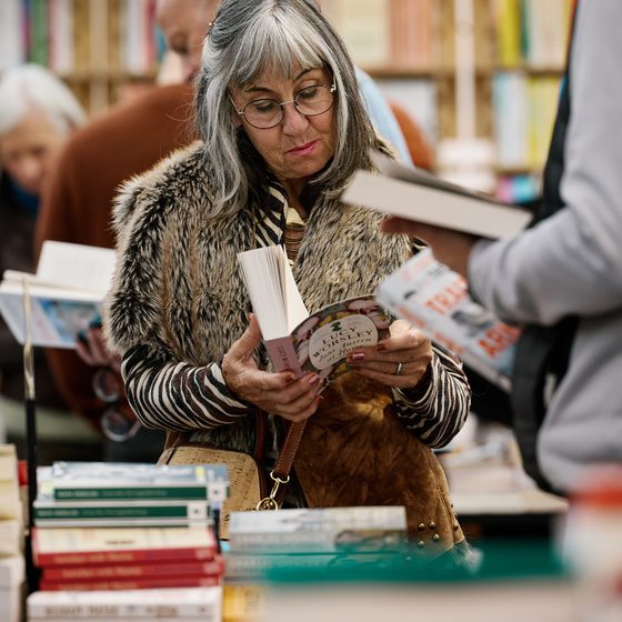 lady reading book in waterstones on site