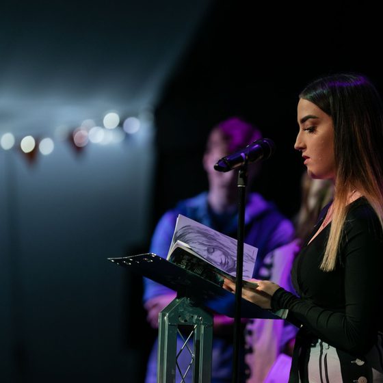 Young person on stage at Write Now