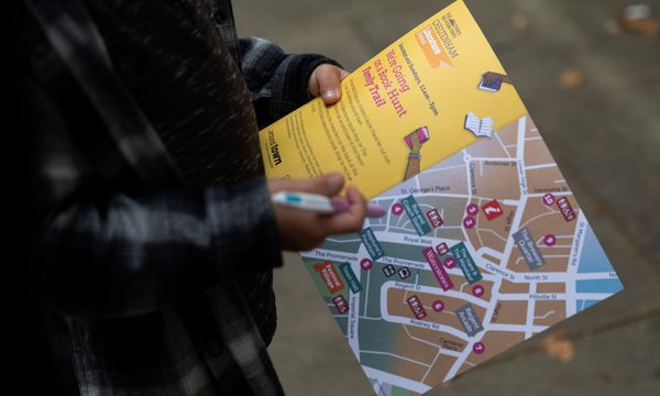 Person looking at map of CLF 2021 book hunt family trail