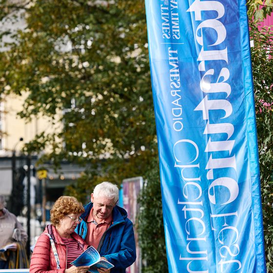 couple reading brochure by clf flag