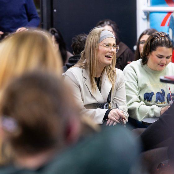 Two women laughing at an event at Cheltenham Literature Festival 2025.