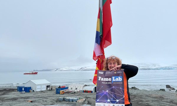 Lyubov Kostova holding a FameLab poster at the South Pole