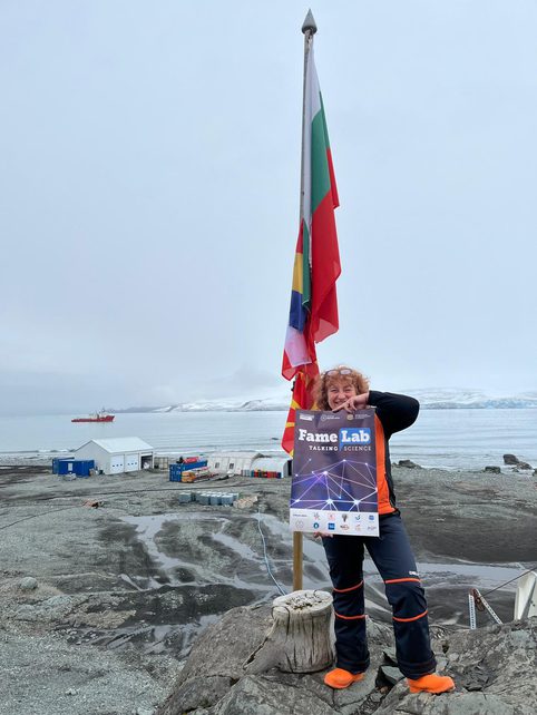 Lyubov Kostova holding a FameLab poster at the South Pole