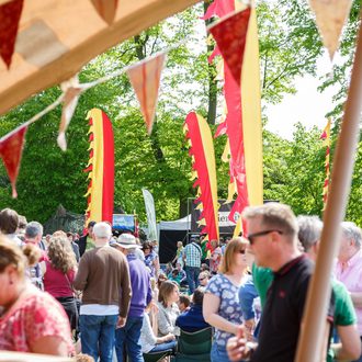 Festival-goers in tent with bunting