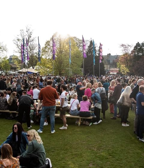 crowd at JF23 - sat on benches and grass