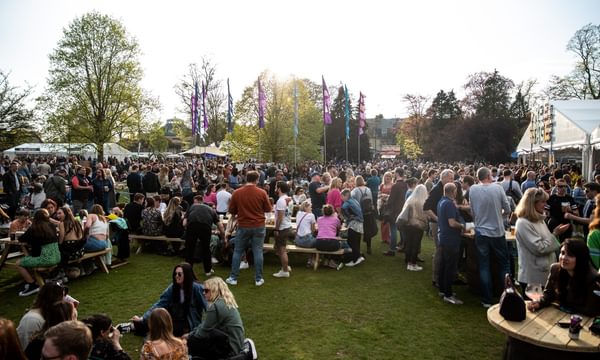 crowd at JF23 - sat on benches and grass