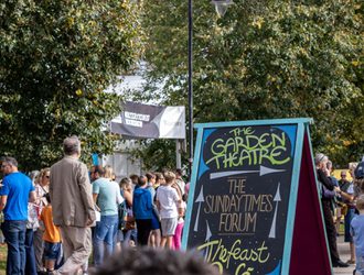A hand-drawn sign showing directions to The Garden Theatre and Sunday Times Forum venues at the Literature Festival.