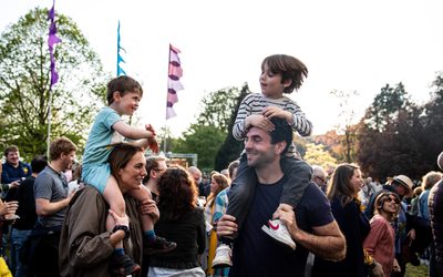 children on shoulders of adults at CJF23 dancing