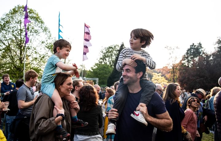 children on shoulders of adults at CJF23 dancing