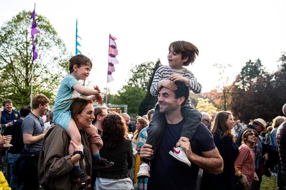 children on shoulders of adults at CJF23 dancing