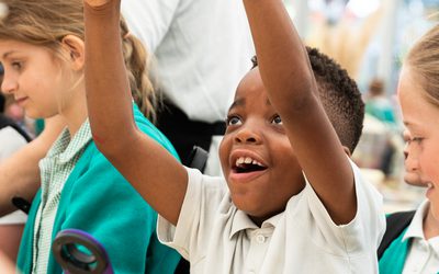 small child with arms in the air