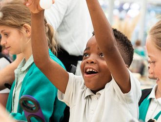 small child with arms in the air