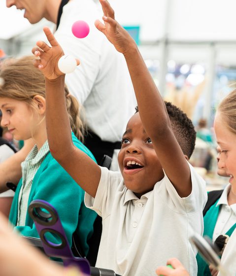small child with arms in the air