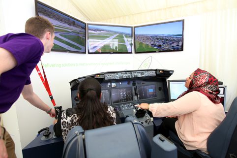 Two people on a flight simulator