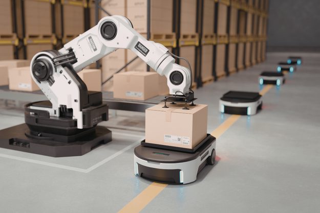 A robotic arm packing boxes