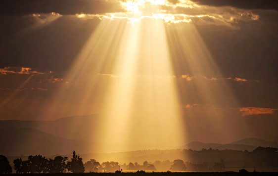 The sun shining through the clouds