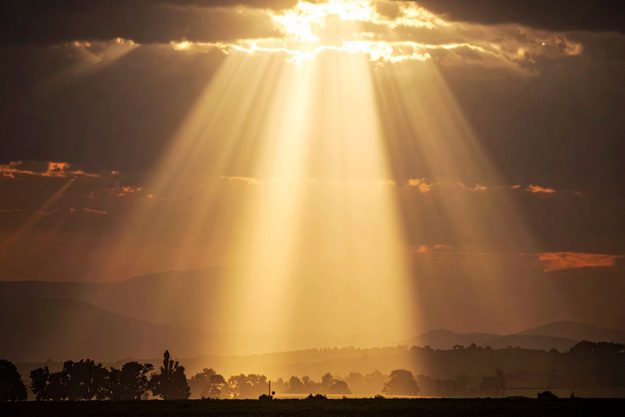 The sun shining through the clouds