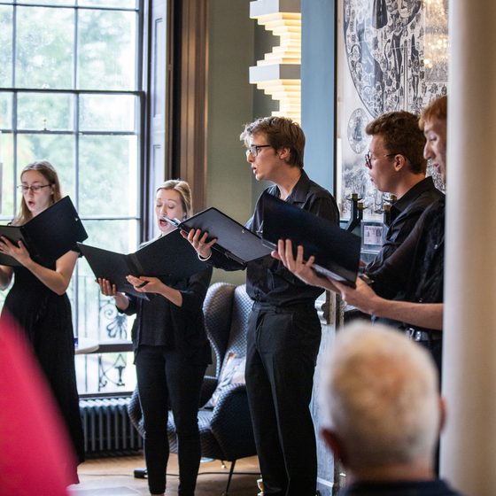 Five singers rehearsing