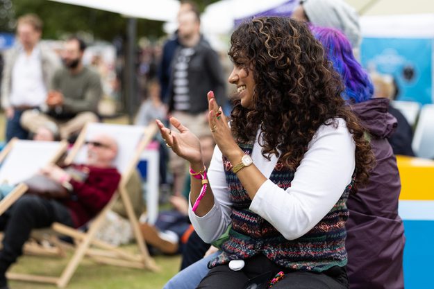 A Festival-goer clapping and smiling at the Jetstream stage