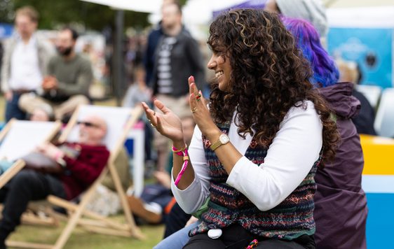 A Festival-goer clapping and smiling at the Jetstream stage