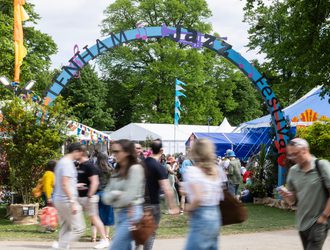 People walking by the Jazz Festival arch