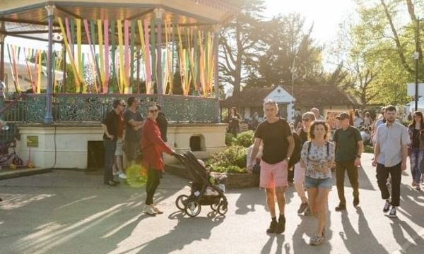 Bandstand with people walking past