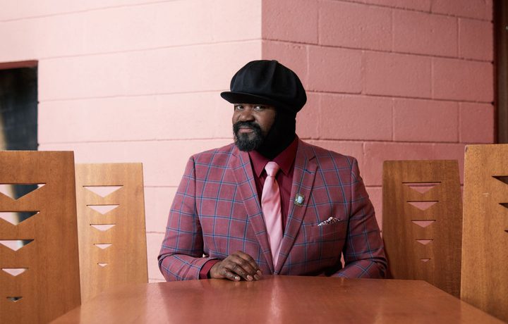 head shot of Gregory porter sat at head of table