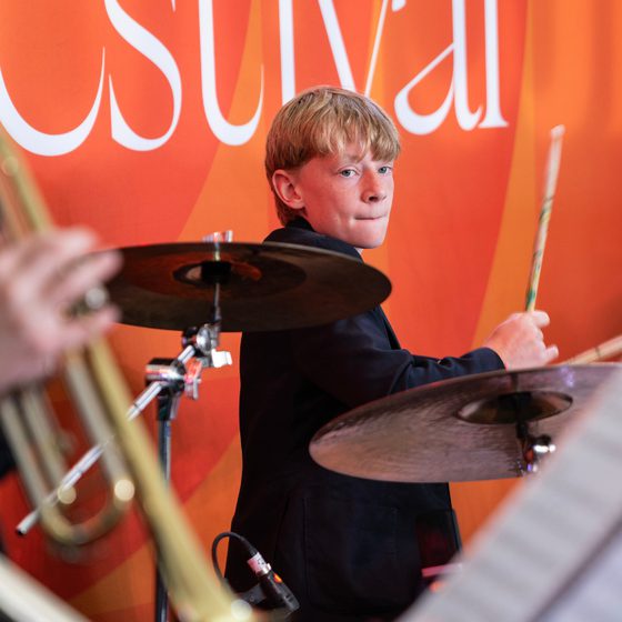 A young boy playing the drum at Jazz It Up 2025