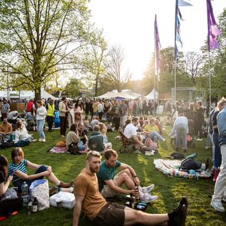 festival-goers sat on grass at JF 23