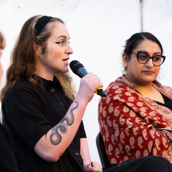 Panelist spealing into microphone at Conference