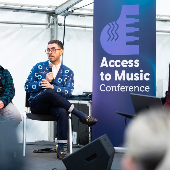 Two panelists on stage at Access to Music Conference