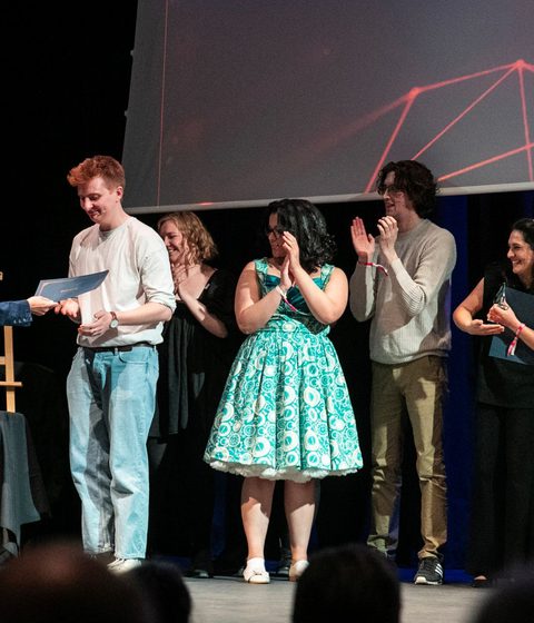 FameLab UK Finalist being presented with an award