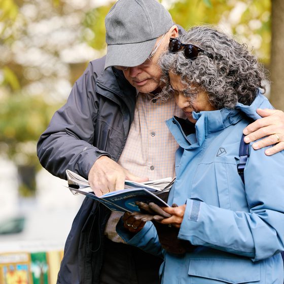 A couple looking through the Festival brochure together