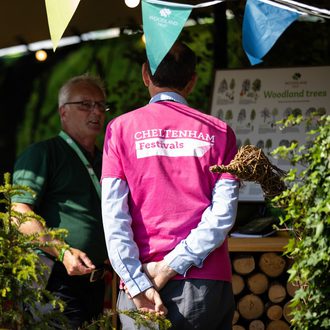 A volunteer on-site at Cheltenham Literature Festival. He is wearing a pink t-shirt.