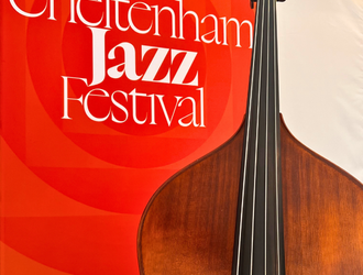 Cello in front of Jazz Festival banner