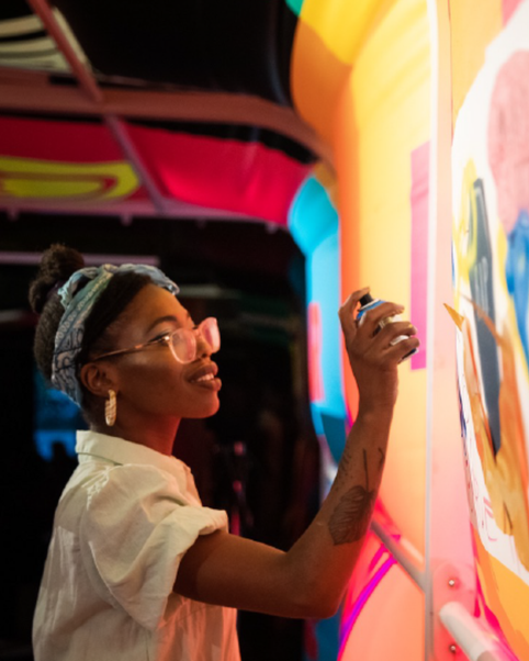 An artist spray painting at VOICEBOX