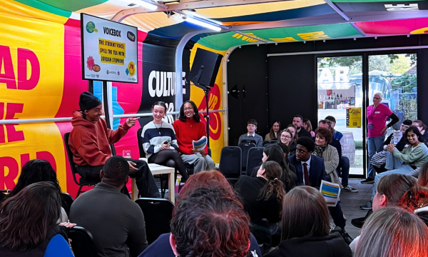Crowd and VOICEBOX speakers on stage