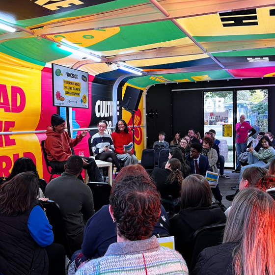 Crowd and VOICEBOX speakers on stage