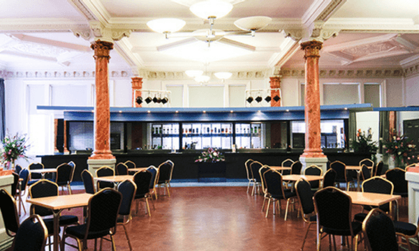 The bar of the Pillar Room from behind some cabaret-style tables.