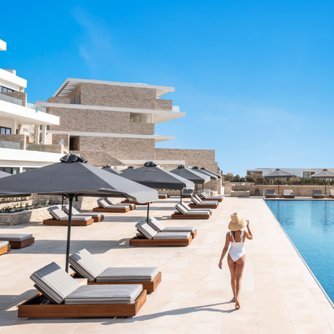 Woman walking alongside a pool